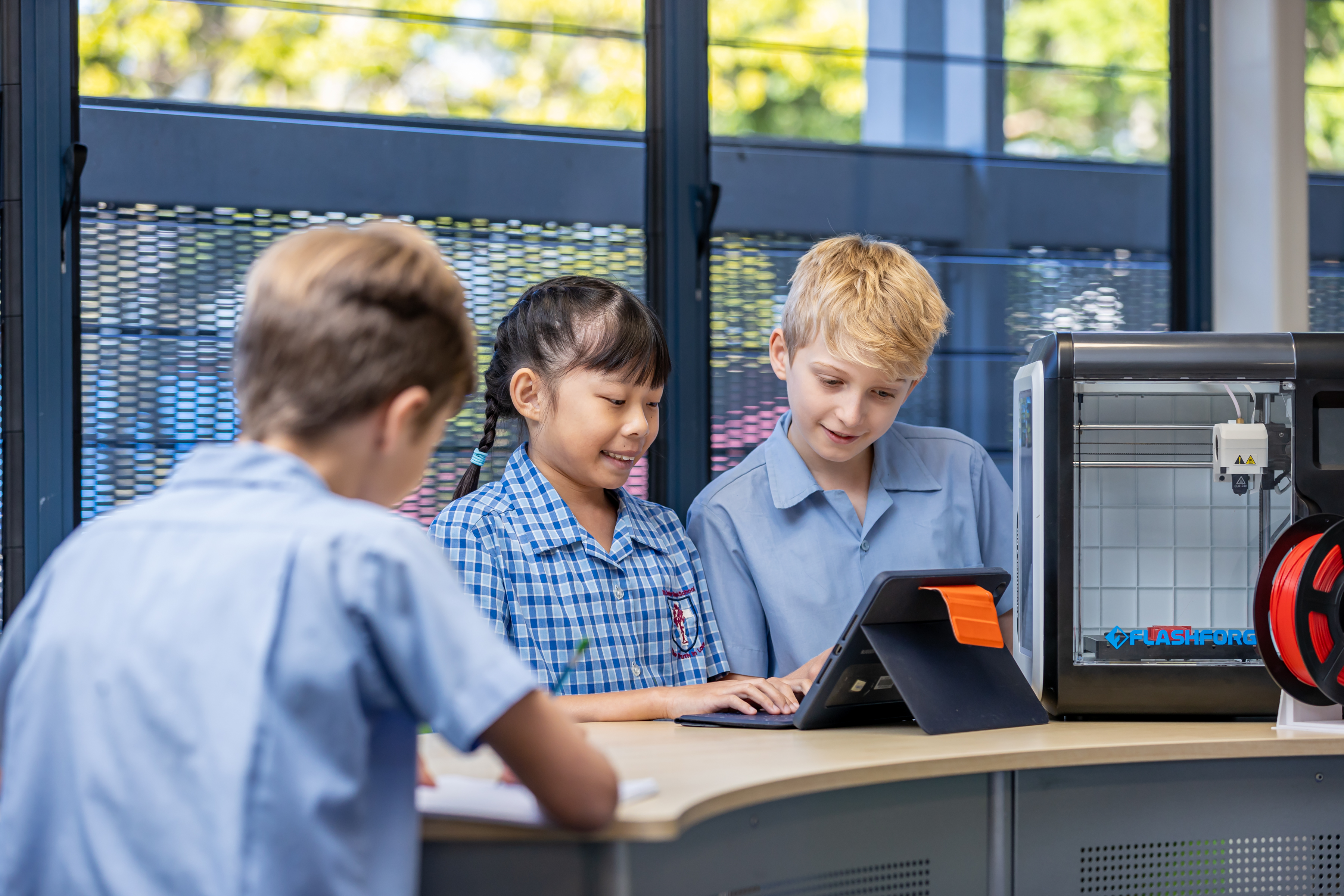 Students collaborating with digital tools and robotics equipment, highlighting hands‑on STEM learning, problem solving and future‑focused learning at St Peter Chanel Primary School